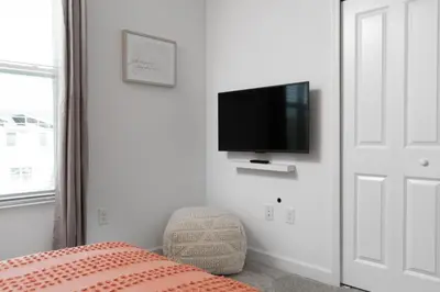a bedroom with a flat screen tv on the wall at Last Minute Disney Private Pool Hot Tub Themed Bedrooms. Book Now 56873 in Kissimmee