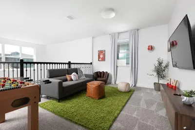 a living room with a couch and a tv at Last Minute Disney Private Pool Hot Tub Themed Bedrooms. Book Now 56873 in Kissimmee