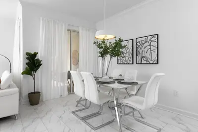 a white dining room with a table and white chairs at Last Minute Disney Getaway Private Pool Themed Bedrooms. Book Now 58079 in Kissimmee