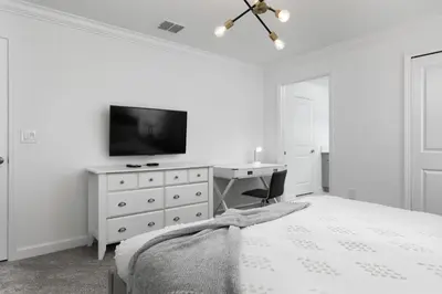 a bedroom with a bed and a desk and a tv at Last Minute Disney Getaway Private Pool Themed Bedrooms. Book Now 58079 in Kissimmee
