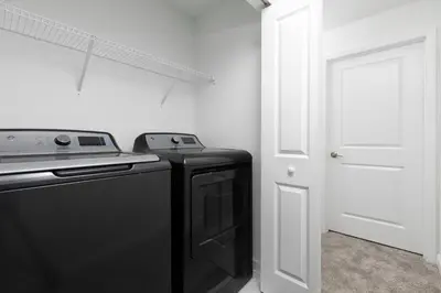 a kitchen with a black stove and a white door at Last Minute Disney Getaway Private Pool Themed Bedrooms. Book Now 58079 in Kissimmee