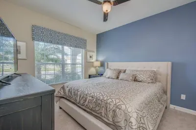a bedroom with a bed and a window and a sink at Last Minute Disney Getaway Townhouse with Private Pool. Book Now 17402 in Kissimmee