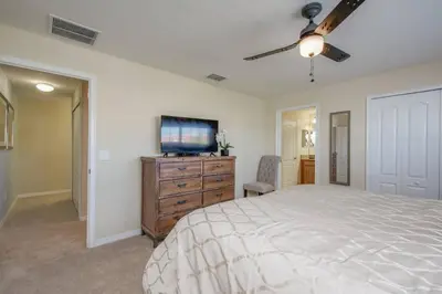 a bedroom with a bed and a flat screen tv at Last Minute Disney Getaway Townhouse with Private Pool. Book Now 17402 in Kissimmee