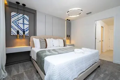 a bedroom with a large white bed in a room at Last Minute Disney Private Pool Hot Tub Game Room Themed Bedrooms. Book Now 90505 in Kissimmee