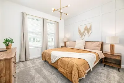 a bedroom with a large bed and a desk at Last Minute Disney Getaway Villa with Private Pool Hot Tub. Book Now 81933 in Kissimmee