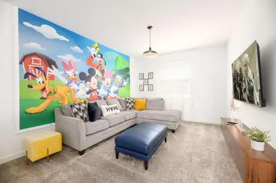 a living room with a couch and a painting on the wall at Last Minute Disney Getaway Villa with Private Pool Hot Tub. Book Now 81933 in Kissimmee