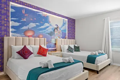 a bedroom with two beds with a painting on the wall at Veranda Palms 8 Bedroom Home with Pool2208 in Kissimmee