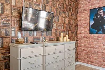 a dresser in a room with a brick wall at Veranda Palms 8 Bedroom Home with Pool2208 in Kissimmee
