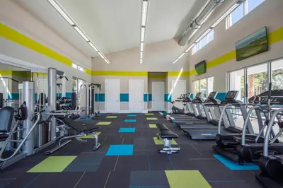 a gym with several treadmills and cardio machines at Veranda Palms 8 Bedroom Home with Pool2208 in Kissimmee