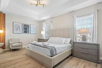 a bedroom with a bed and a chair and a window at Veranda Palms 8 Bedroom Home with Pool2208 in Kissimmee