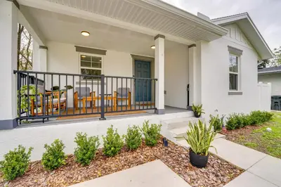a home with a balcony with chairs and plants at Modern Florida Bungalow 3 Miles to Winter Garden! in Montverde