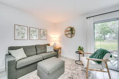 a living room with a couch and a window at Modern Florida Bungalow 3 Miles to Winter Garden! in Montverde