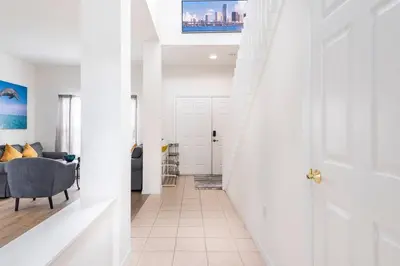 a hallway with a door leading to a living room at Comfortable House with hot tub close to Disney in Kissimmee