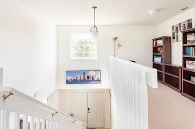 a white staircase in a home with a window at Comfortable House with hot tub close to Disney in Kissimmee
