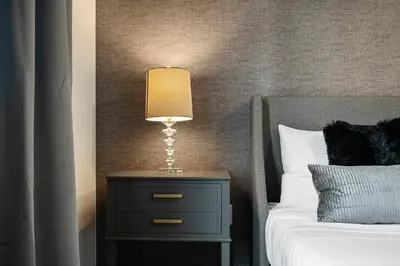 a lamp on a night stand next to a bed at Wonderful towhouse very close to Disney in Orlando