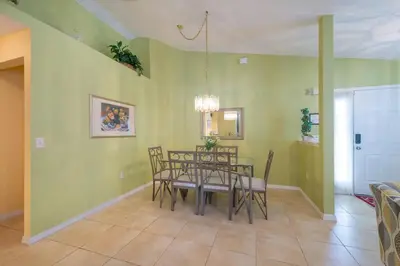 a dining room with a table and chairs at 4br/3ba Disney Area Luxury Resort with pool/spa in Orlando