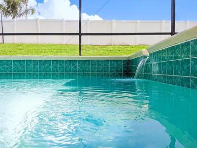 a swimming pool with a water fountain at 4 Bed 2269 in Kissimmee
