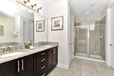 a bathroom with two sinks and a shower at Charming Home With Themed Rooms, Game Room And Waterpark & Resort Access Near Disney At Encore Resorts Reunion - 300Pn in Kissimmee