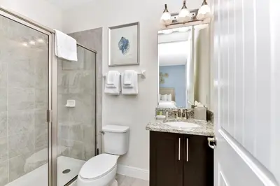 a bathroom with a toilet and a sink and a shower at Charming Home With Themed Rooms, Game Room And Waterpark & Resort Access Near Disney At Encore Resorts Reunion - 300Pn in Kissimmee