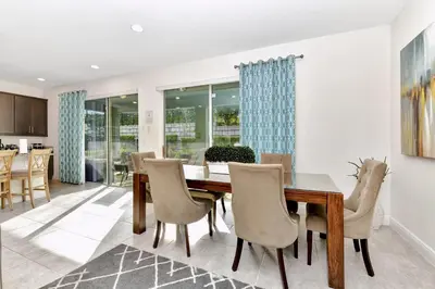 a dining room with a table and chairs at Charming Home With Themed Rooms, Game Room And Waterpark & Resort Access Near Disney At Encore Resorts Reunion - 300Pn in Kissimmee