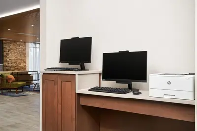 two computer monitors sitting on a desk in an office at Fairfield by Marriott Inn & Suites Orlando at Millenia in Orlando