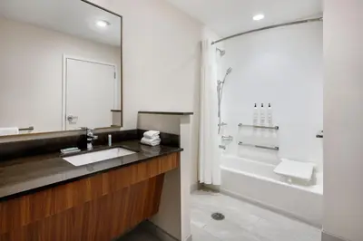 a bathroom with a sink and a bath tub at Fairfield by Marriott Inn & Suites Orlando at Millenia in Orlando