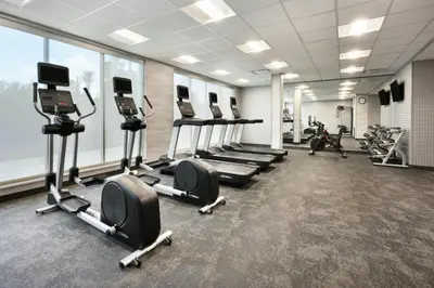 a gym with several treadmills and cardio machines at Fairfield by Marriott Inn & Suites Orlando at Millenia in Orlando