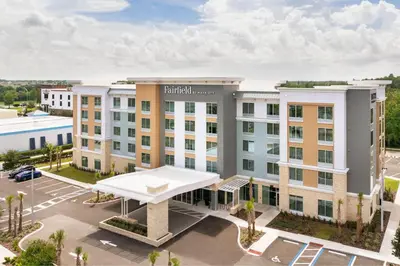 an aerial view of a hotel with a parking lot at Fairfield by Marriott Inn & Suites Orlando at Millenia in Orlando