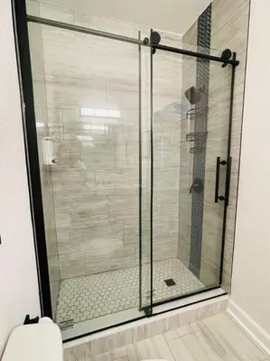 a glass shower in a bathroom with a toilet at Newly Renovated First Floor 3Bed & 2 Bath, OUTDOOR POOL, 10-min to Disneyworld & Animal Kingdom! in Kissimmee