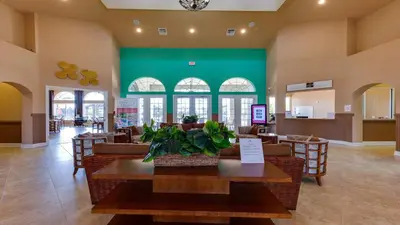 a restaurant with a table and chairs and a green wall at Family-Friendly Luxury Home Near Disney & More in Kissimmee