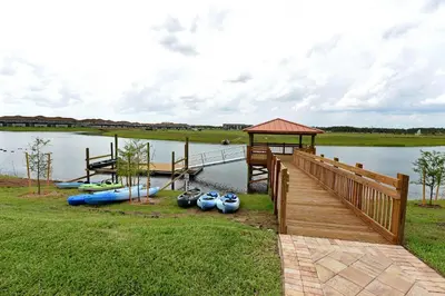 a dock with a bunch of boats on a lake at Luxurious 10-Bed Lakefront Retreat Near Disney in Kissimmee