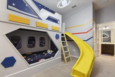 a childs room with a bunk bed and a slide at Spacious 12BR Disney Themed Home Pool/SPA/BBQ/Game in Kissimmee