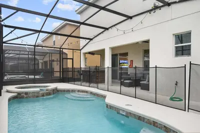 a swimming pool in the middle of a house at Spacious 12BR Disney Themed Home Pool/SPA/BBQ/Game in Kissimmee
