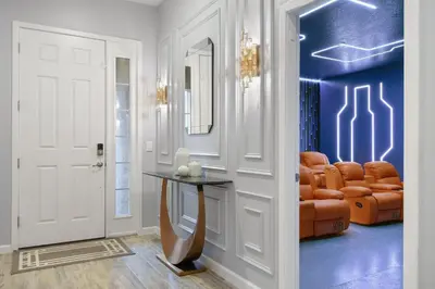 a living room with a table and a couch at NEW Disney Themed 12BR Home Pool/SPA/Game/Tiki Bar in Kissimmee