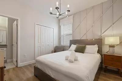 a bedroom with a bed with a white towel on it at Elegant Home with Pool & Spa, Close to Disney in Kissimmee