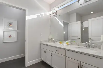 a bathroom with two sinks and a large mirror at Elegant Home with Pool & Spa, Close to Disney in Kissimmee
