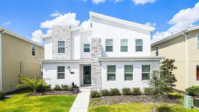 a white house with a lawn in front of it at Disney-Themed Oasis with Private Pool & Spa in Kissimmee