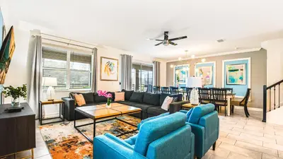 a living room with a couch and a table at Elegant Retreat with Private Spa & Pool in Kissimmee