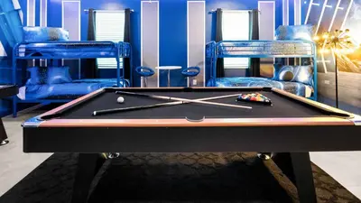 a pool table in a room with two bunk beds at Elegant Retreat with Private Spa & Pool in Kissimmee