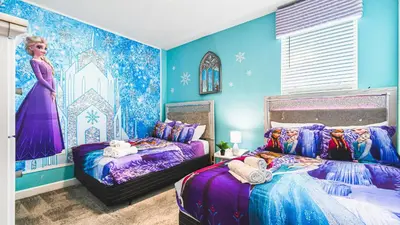 a bedroom with two beds and a wall with a mermaid mural at Storey Lake Resort 6br Family Villa Pool by Disney in Kissimmee