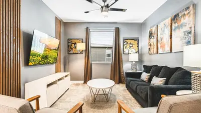 a living room with a couch and a table at Storey Lake Resort 6br Family Villa Pool by Disney in Kissimmee