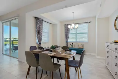 a dining room with a table and chairs at Storey Lake 2BR Cozy Resort Home Close to Disney in Kissimmee