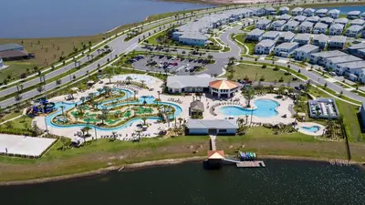 an aerial view of a resort with several pools at Storey Lake 2BR Cozy Resort Home Close to Disney in Kissimmee
