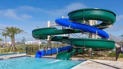 a water slide at a resort with a pool at Storey Lake Getaway Pool SPA Theater in Kissimmee