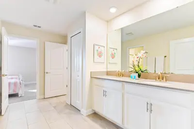 a bathroom with two sinks and a mirror at Resort Home: Game Room, Pool, Near Disney in Kissimmee