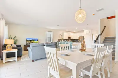 a dining room and living room with a table and chairs at Resort Home: Game Room, Pool, Near Disney in Kissimmee