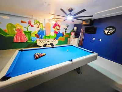 a billiard table in a room with a mural at Lakeview Luxury Oasis in Kissimmee