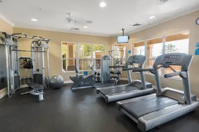 a gym with treadmills and machines in a room at T2501M Windsor Hills Resort 3Bedrm Private Pool in Orlando