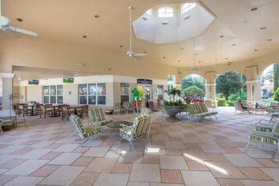 a large room with chairs and tables and a building at T2501M Windsor Hills Resort 3Bedrm Private Pool in Orlando