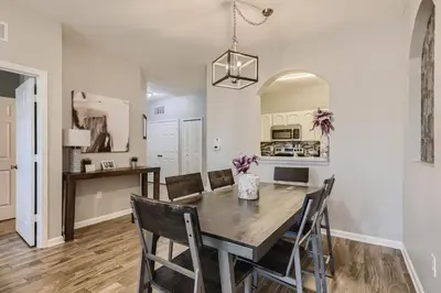 a kitchen and dining room with a wooden table and chairs at C2821-303 Windsor Hills Resort 3 Bedrm Water Park in Orlando